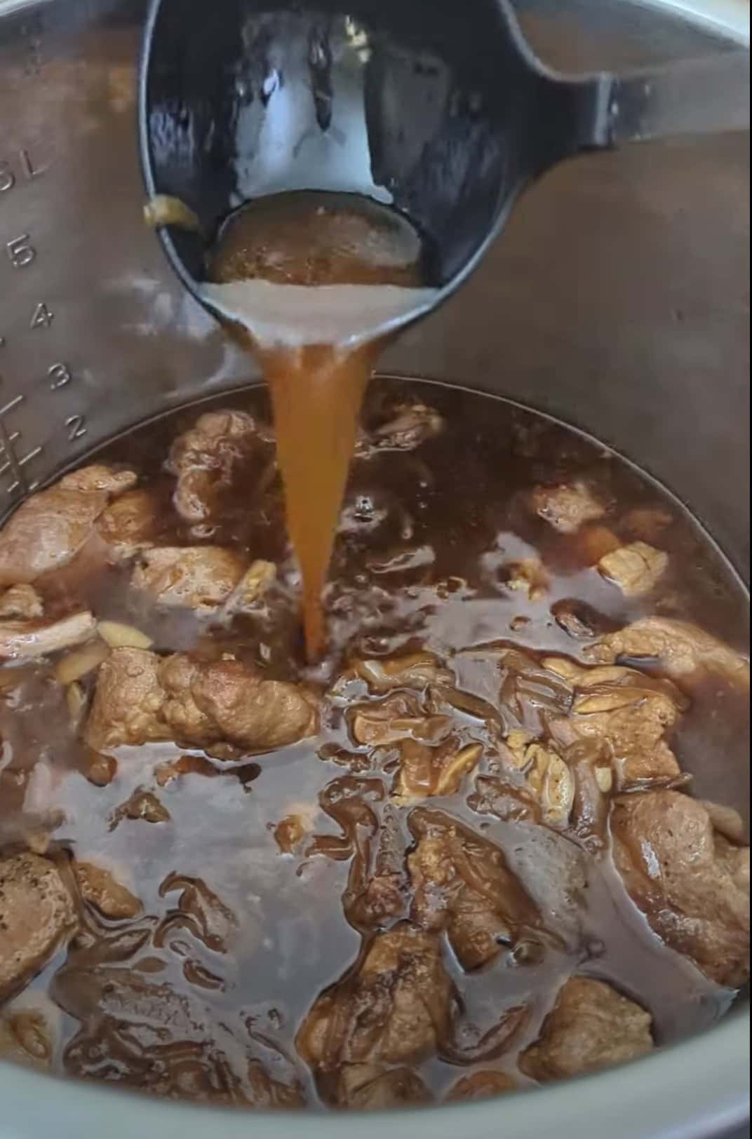 Image depicting amount of liquid released in the Instant Pot after pressure cooking adobo for 25 minutes