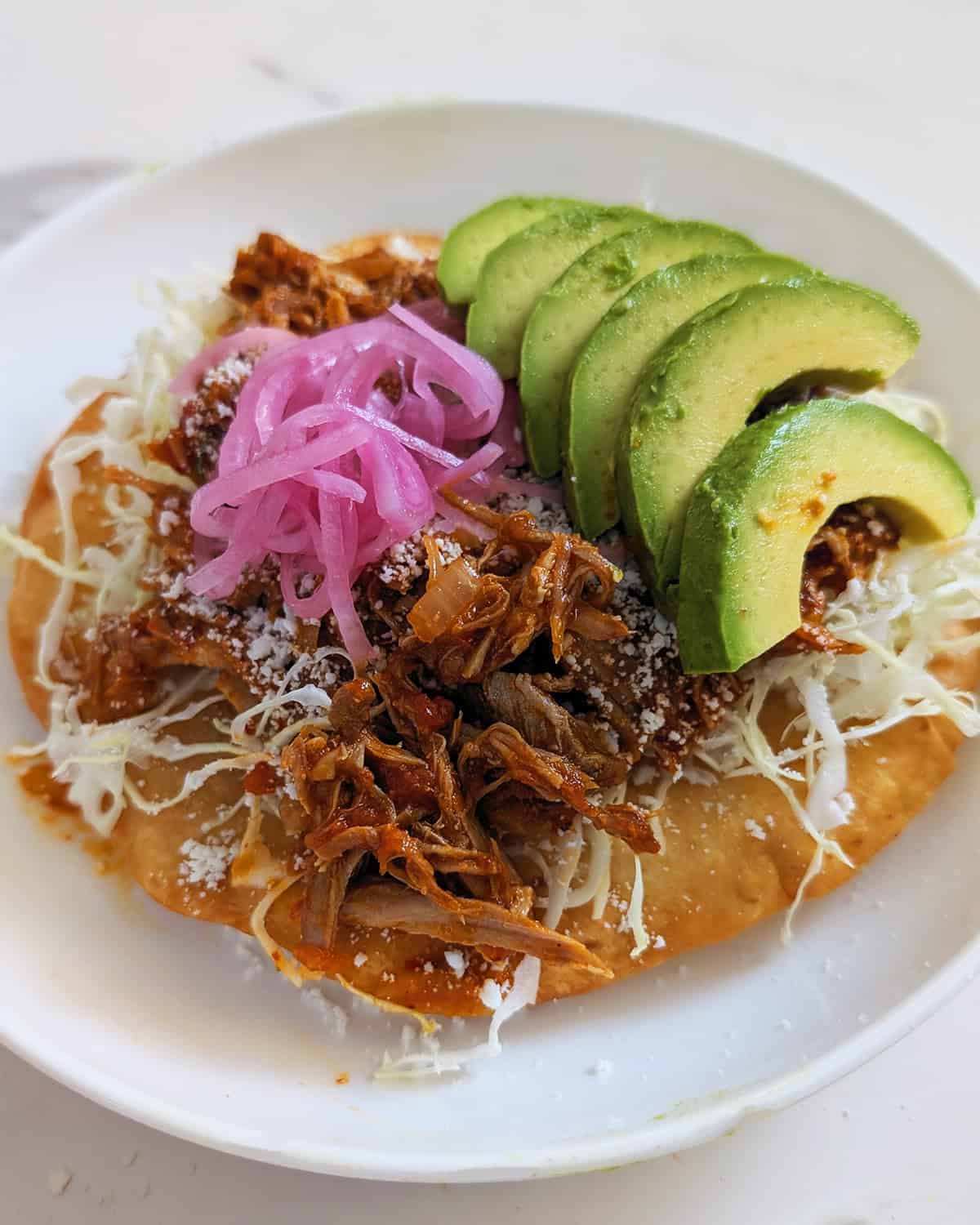 Mexican food with avocado and meat.