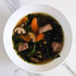 a bowl of pork rib watercress soup on a white marbled top